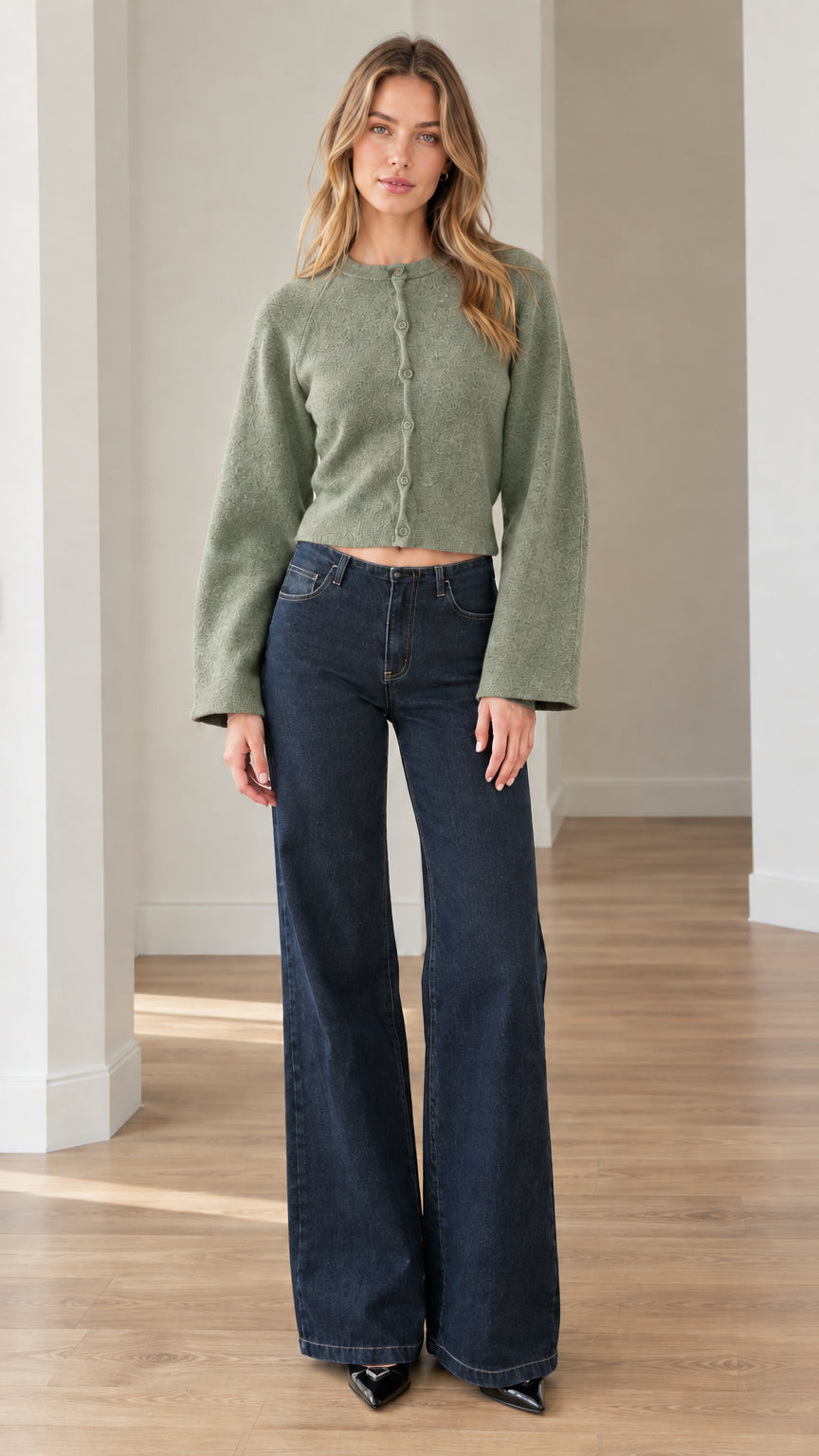 Model wearing sage green cropped textured knit cardigan styled with wide-leg jeans