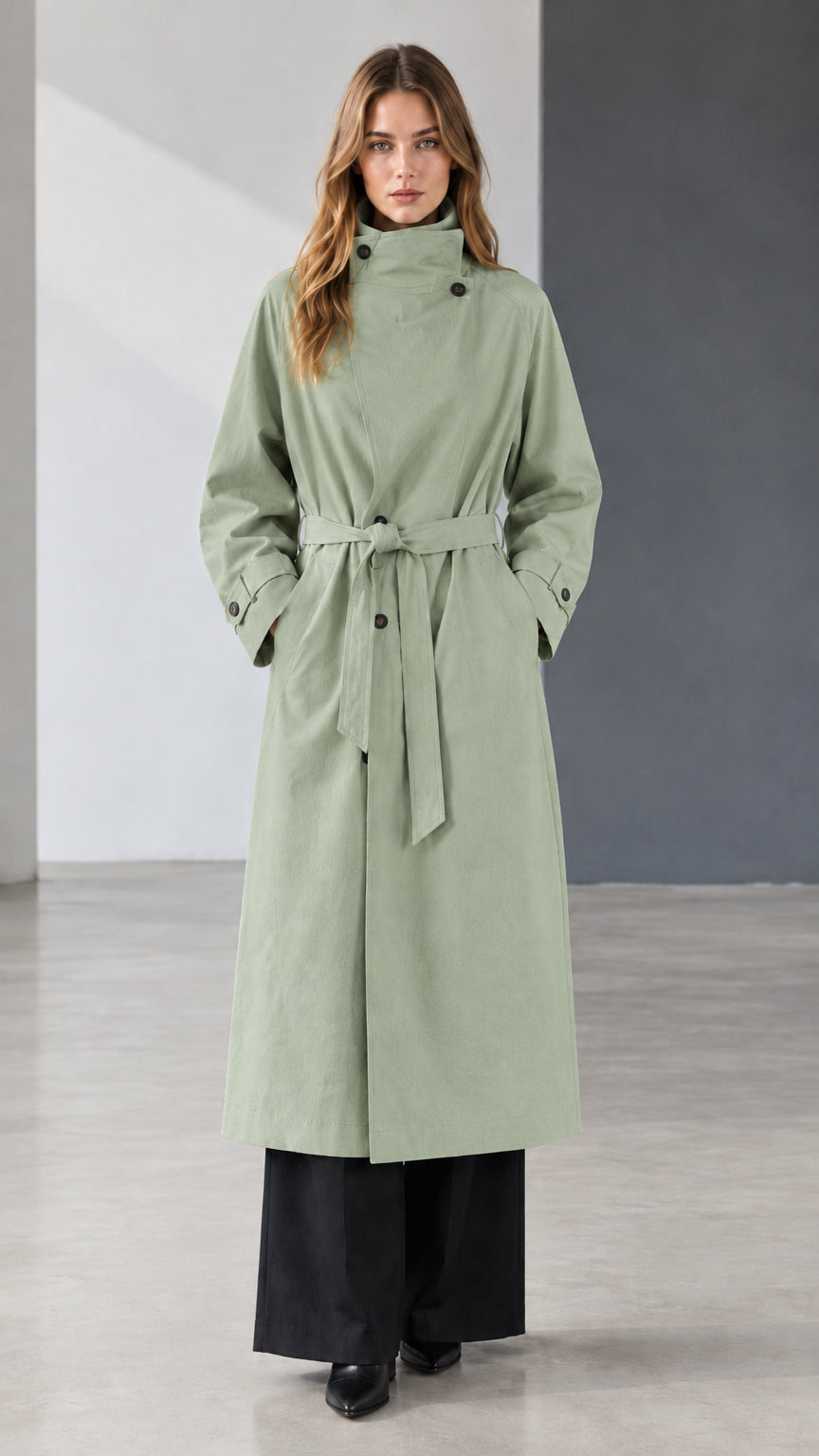 Front view of model wearing sage green belted longline trench coat