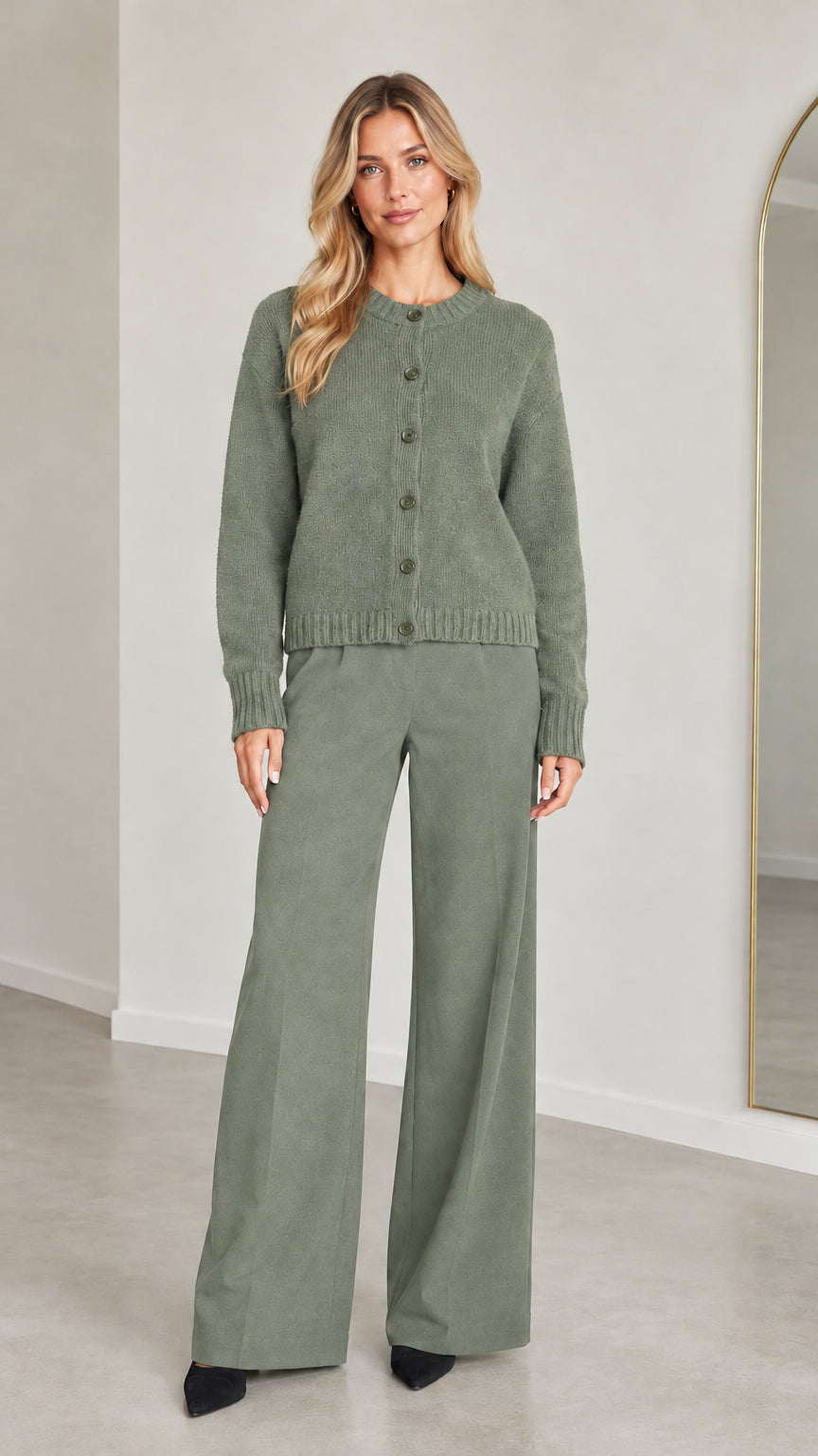 Front view of model wearing Sage Green knit button-down cardigan and wide-leg trousers