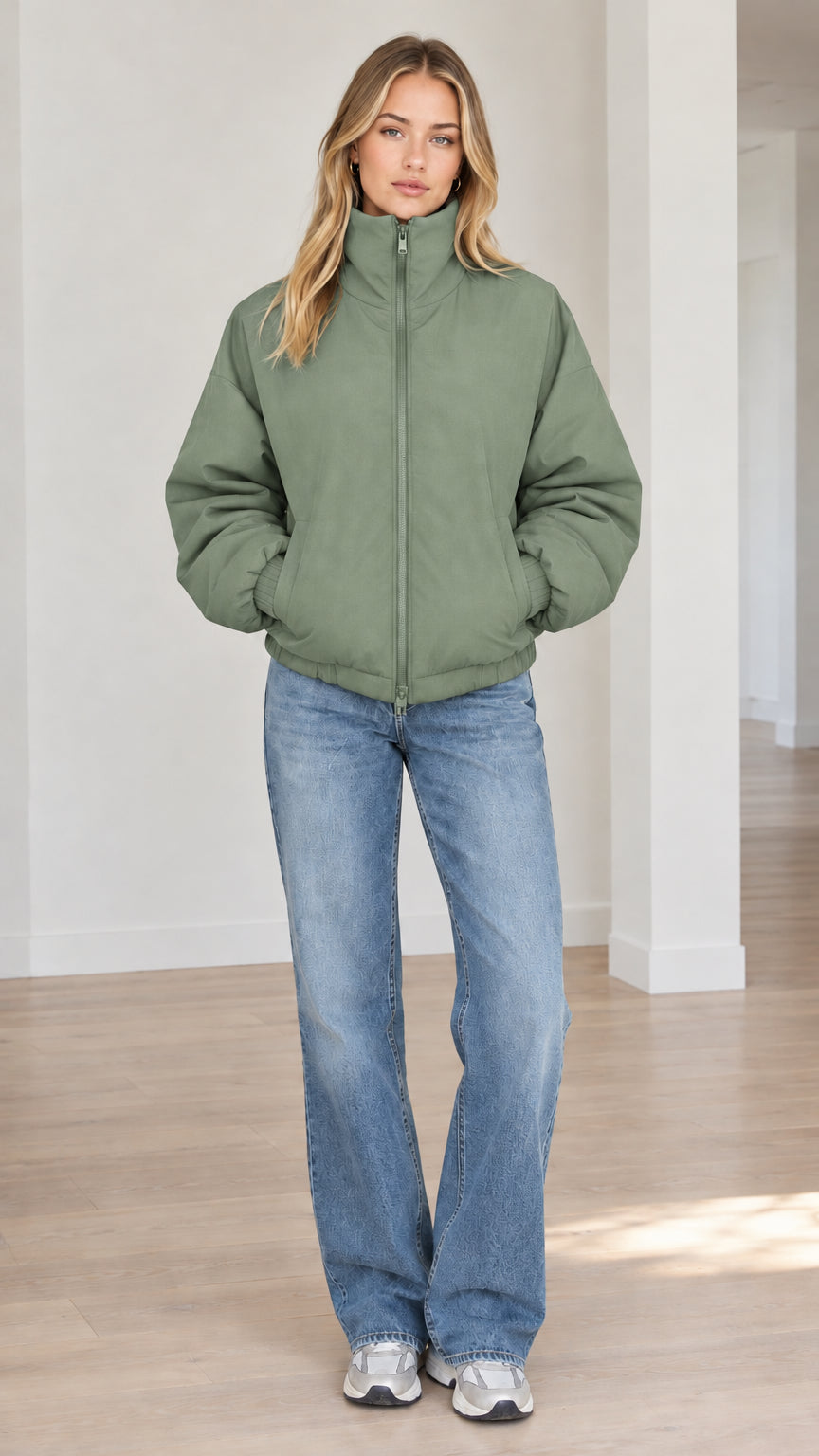 Front view of model wearing sage green stand-collar zip-up puffer jacket
