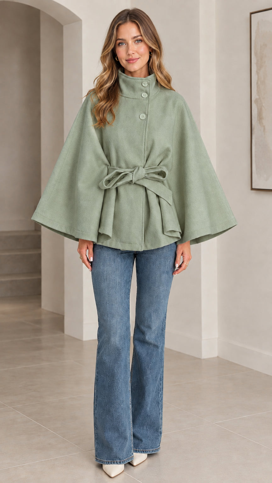 Front view of sage green high neck belted cape coat with front button closure