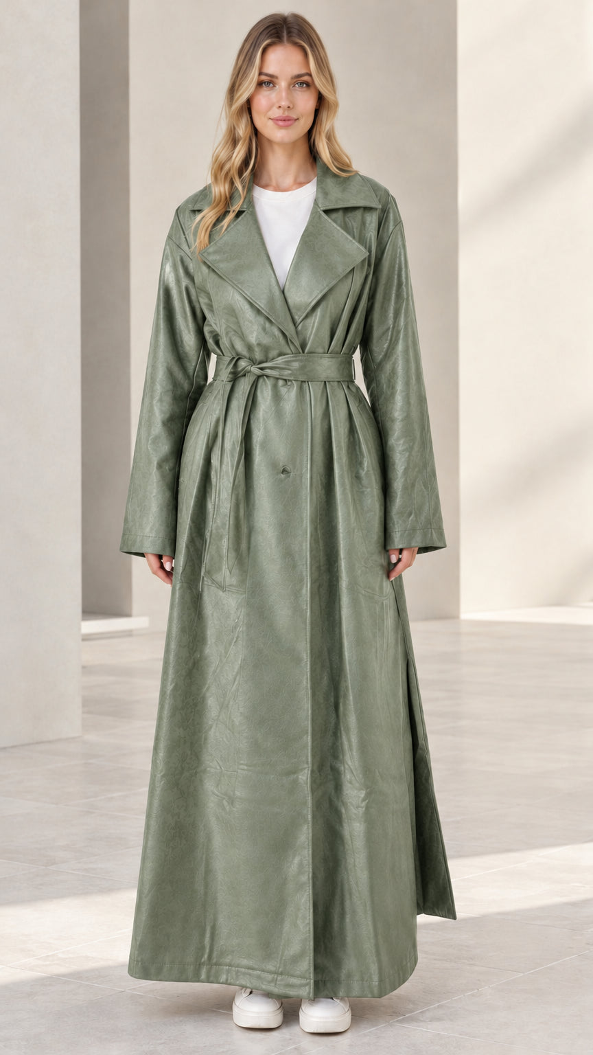 Front view of woman wearing sage green maxi faux leather trench coat