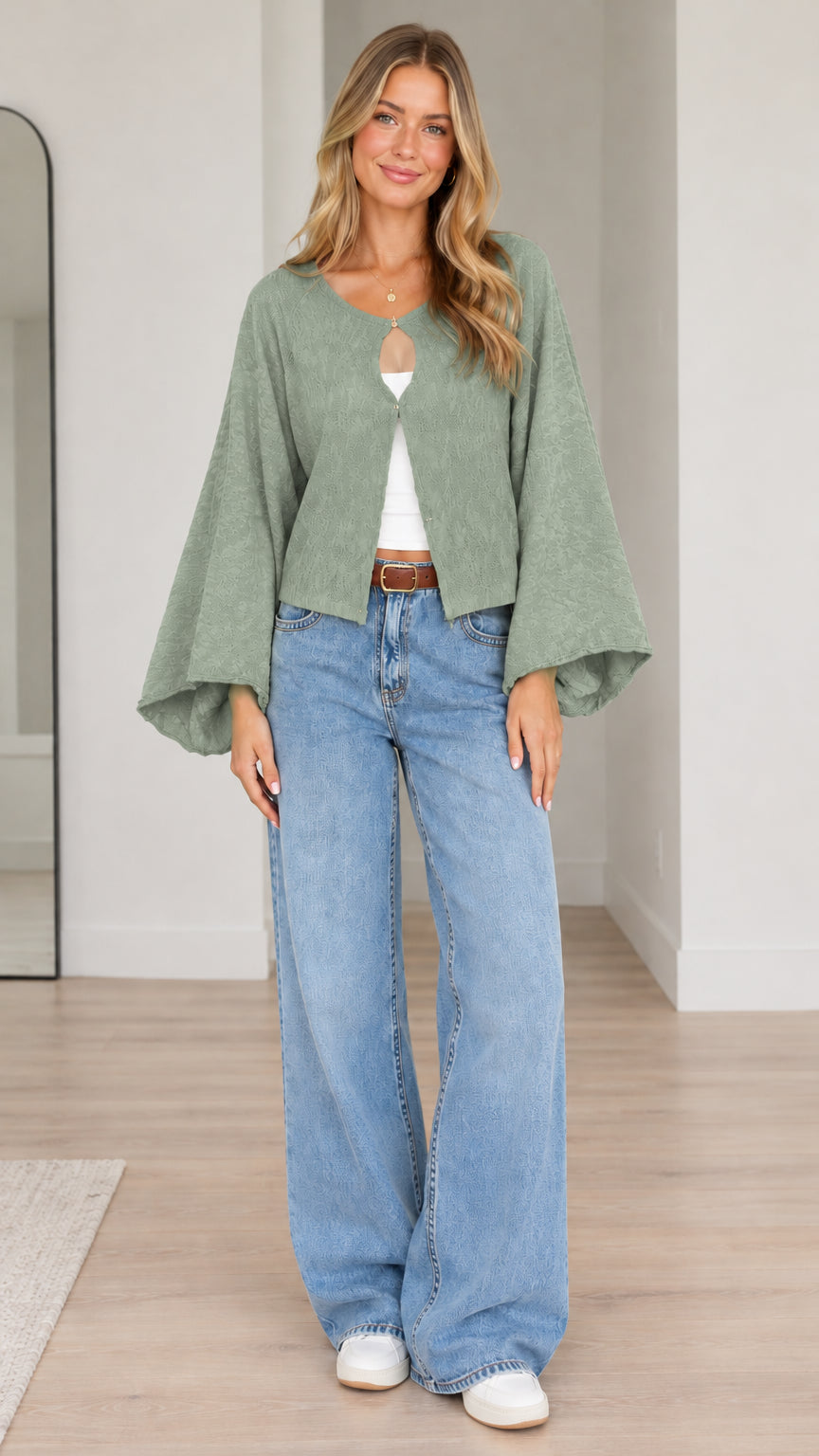 Model wearing sage green textured bell sleeve cardigan