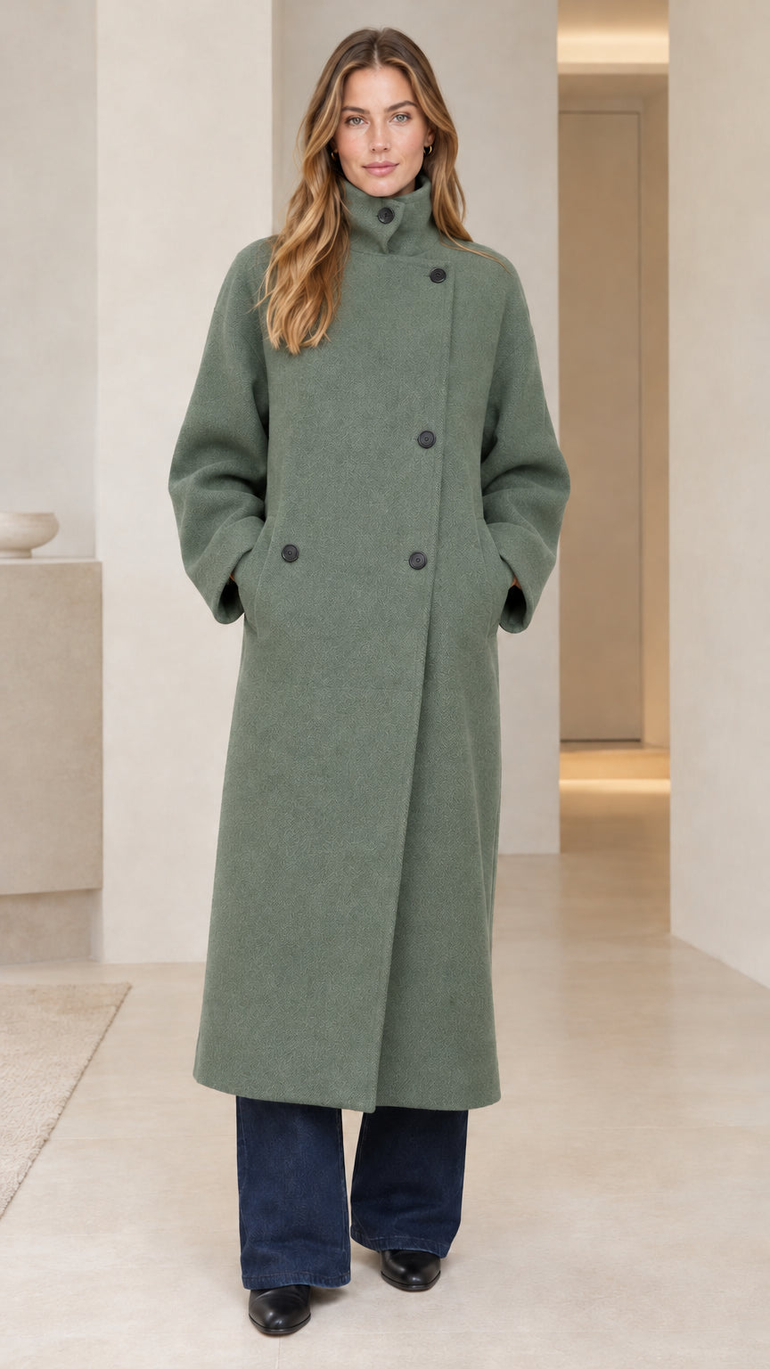 Front view of model wearing sage green longline high neck tailored overcoat