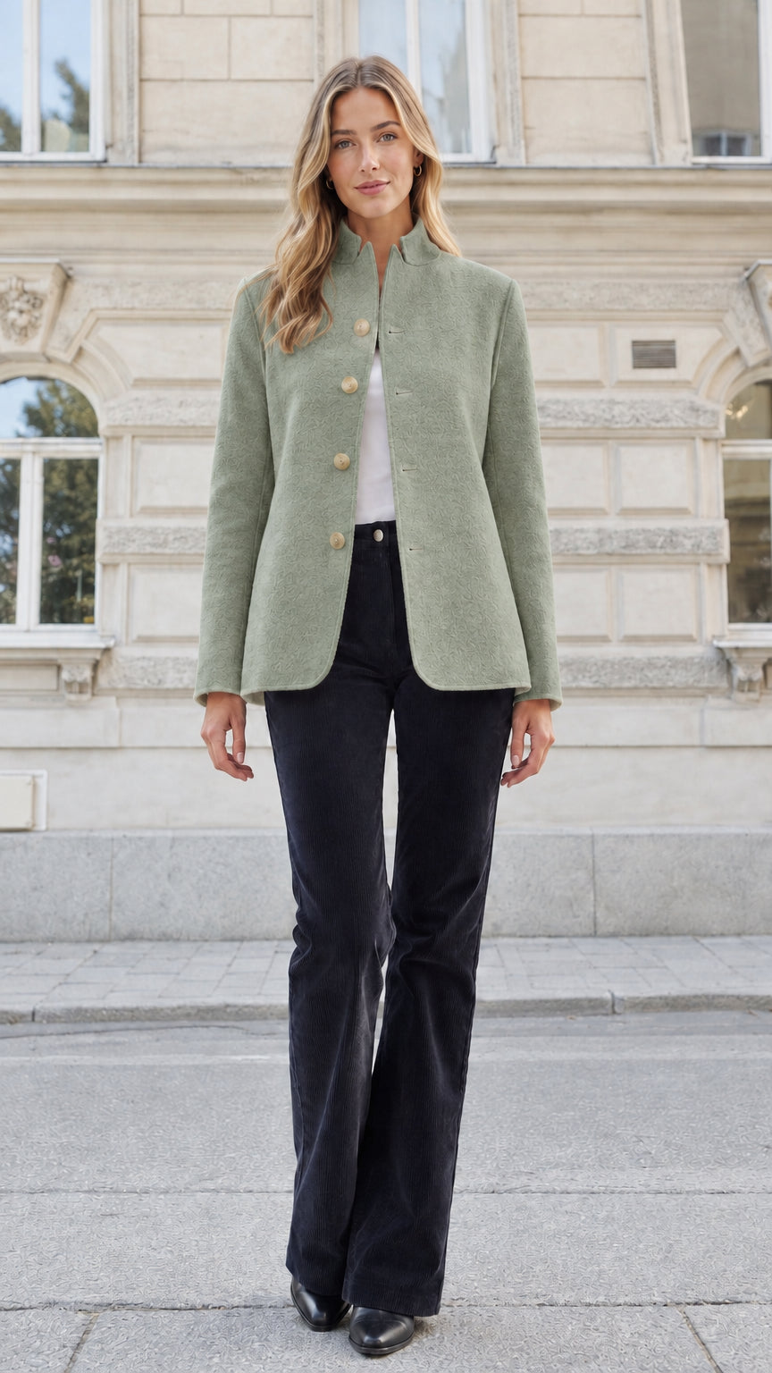 Front view of a woman wearing a sage green textured stand collar tailored blazer jacket