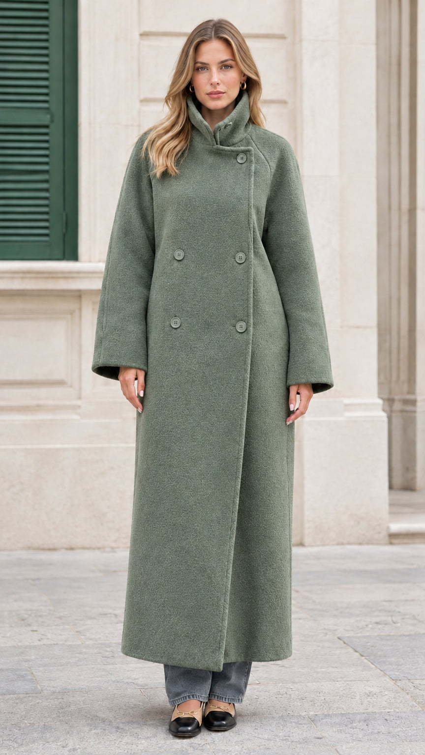 Front view of the sage green double-breasted maxi overcoat on model