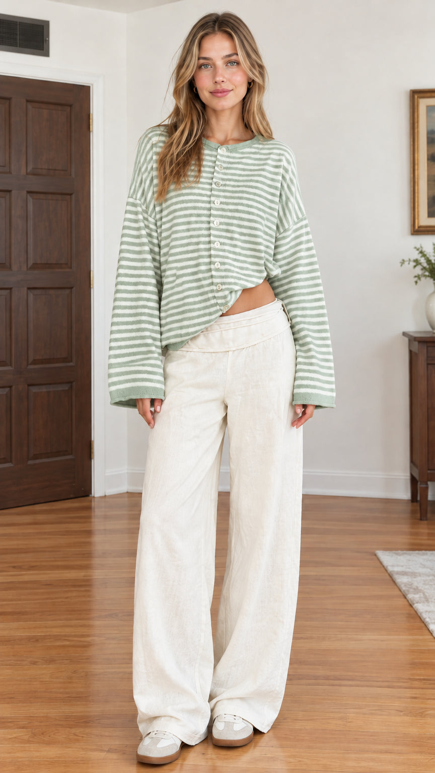 Full-length studio shot of sage green and white striped button-front cardigan on model