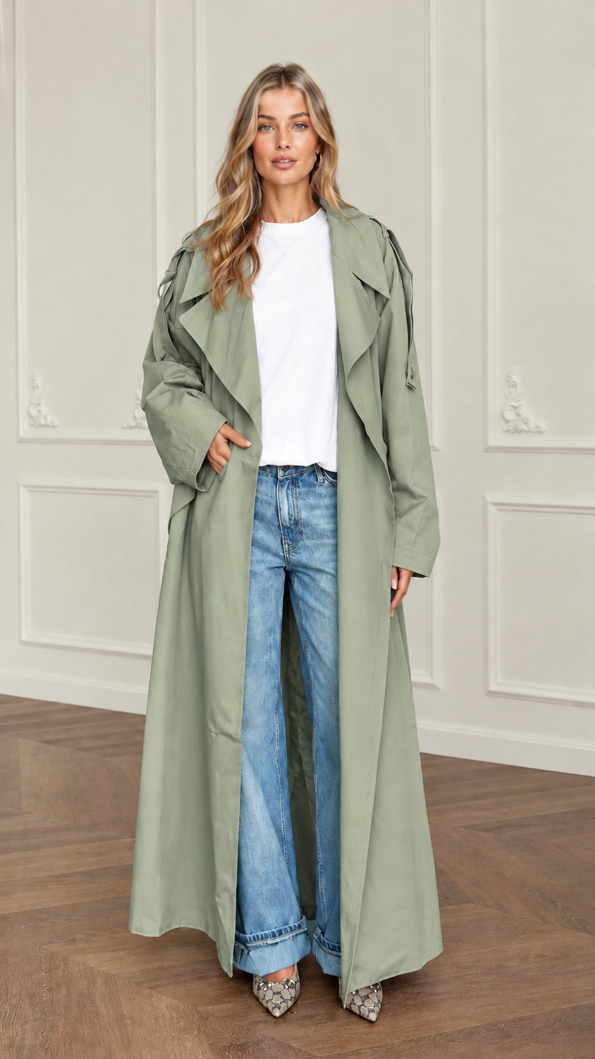 Front view of woman wearing sage green longline drape trench coat