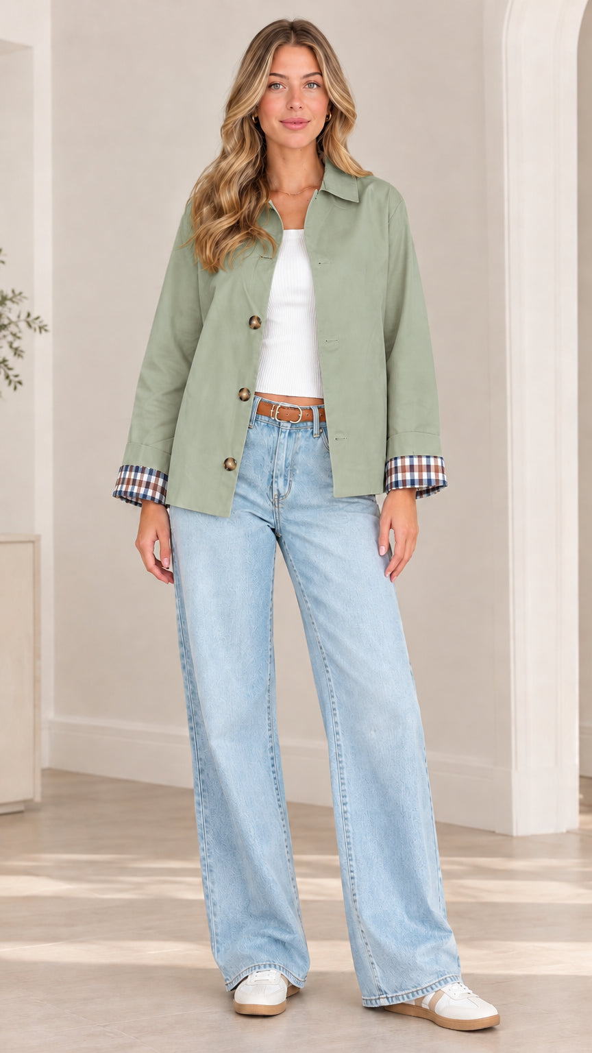 Front view of model wearing sage green collared jacket with contrast plaid cuffs