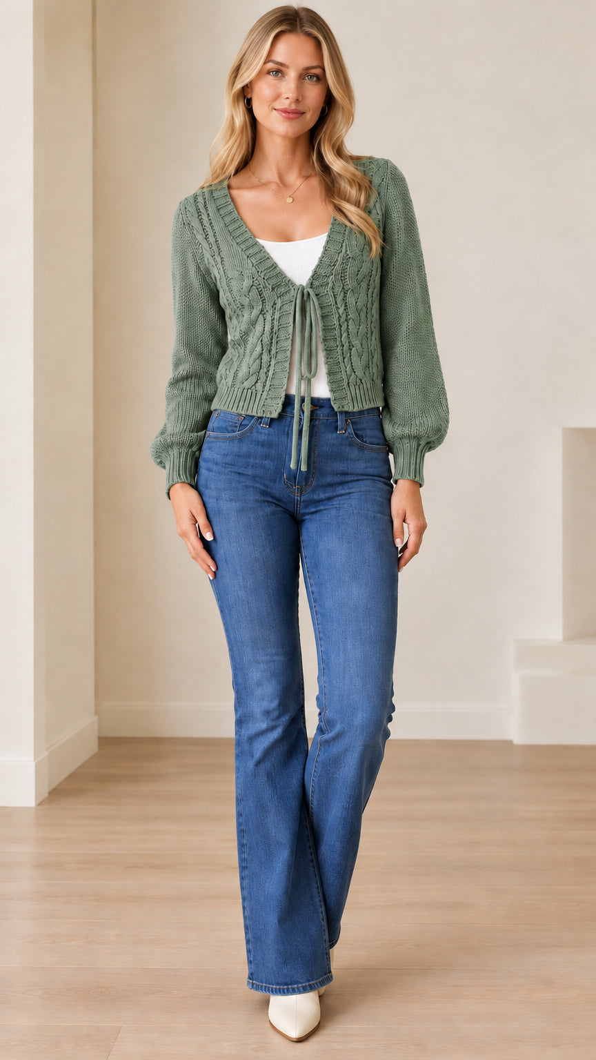 Full front view of a model wearing the sage green cable knit cropped tie-front cardigan