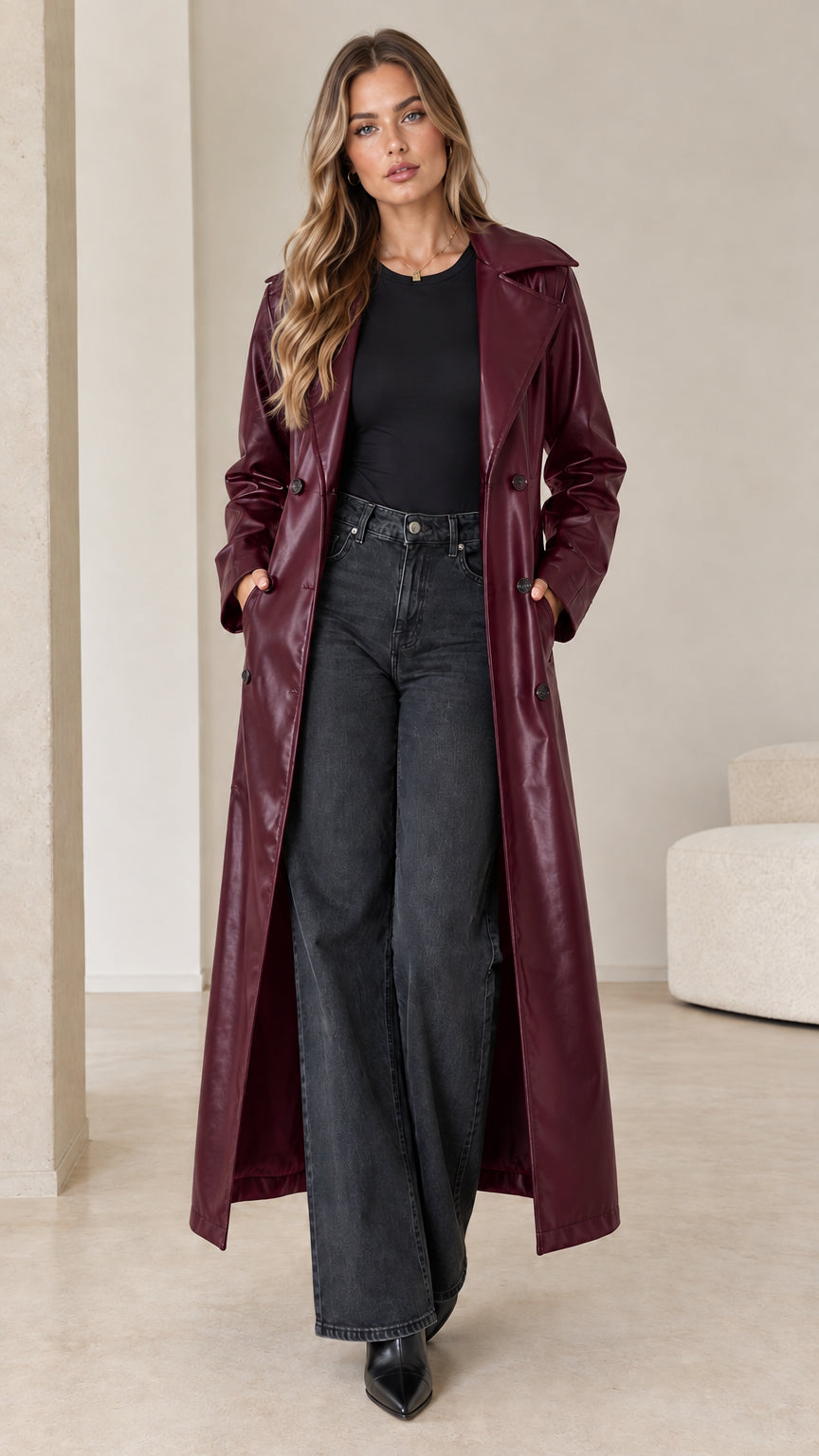 Front view of model wearing a burgundy wine red faux leather maxi trench coat with open front styling