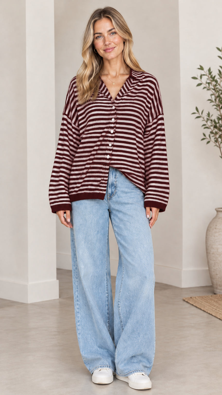 Front full-length view of woman wearing burgundy and white striped collared cardigan sweater