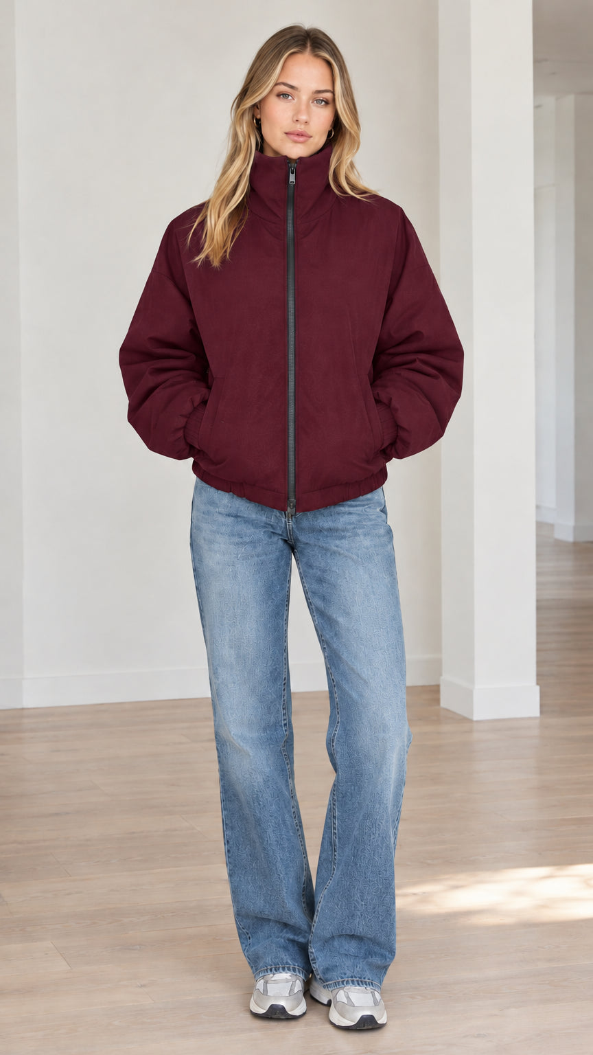 Front view of model wearing burgundy wine-red stand-collar zip-up puffer jacket