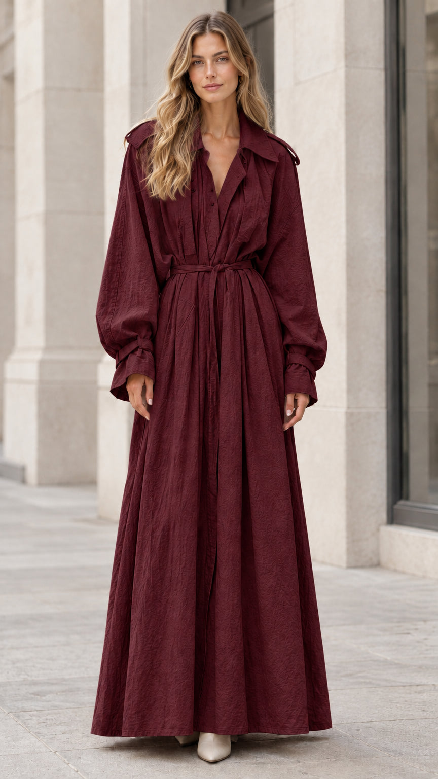 Model wearing the long sleeve belted trench maxi dress in deep burgundy wine