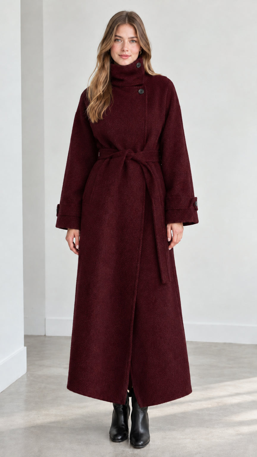 Front view of model wearing burgundy wine high collar belted maxi coat