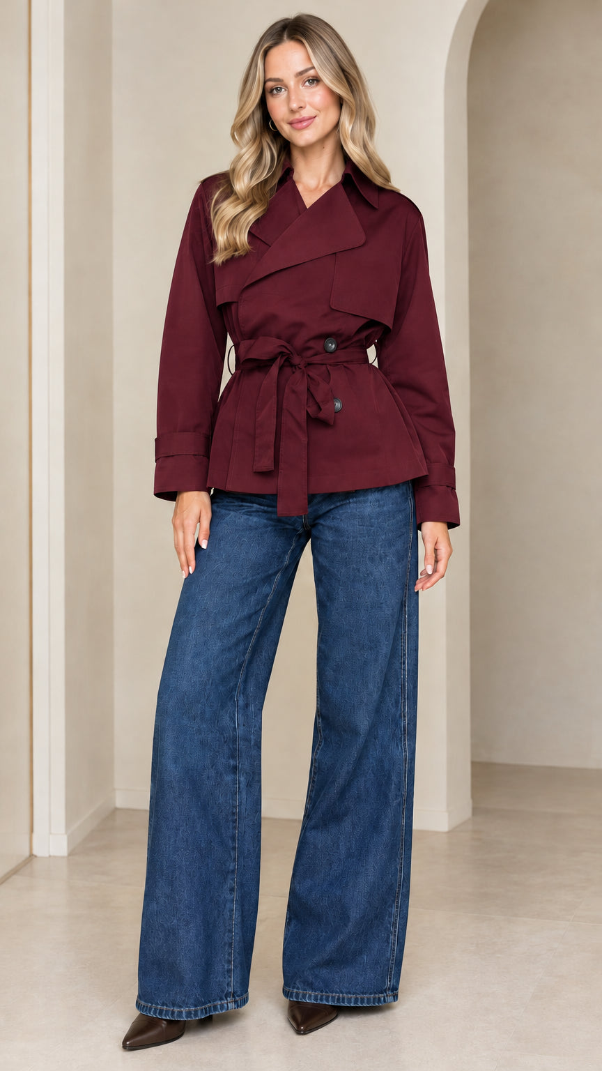 Front view of model wearing the cropped belted trench jacket in rich burgundy red
