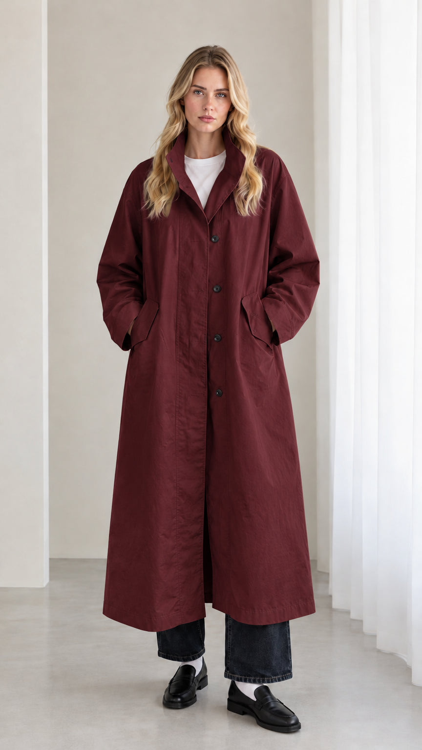 Front view of woman wearing burgundy wine longline trench overcoat