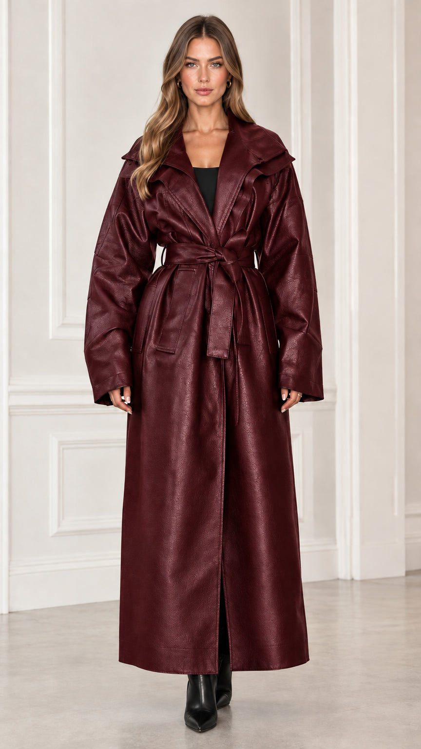 Front view of model wearing burgundy wine red maxi faux leather trench coat
