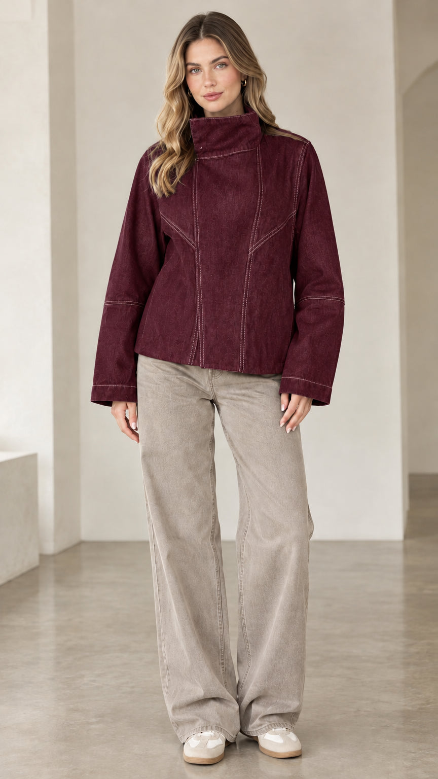 Model wearing burgundy high neck contrast seam denim jacket