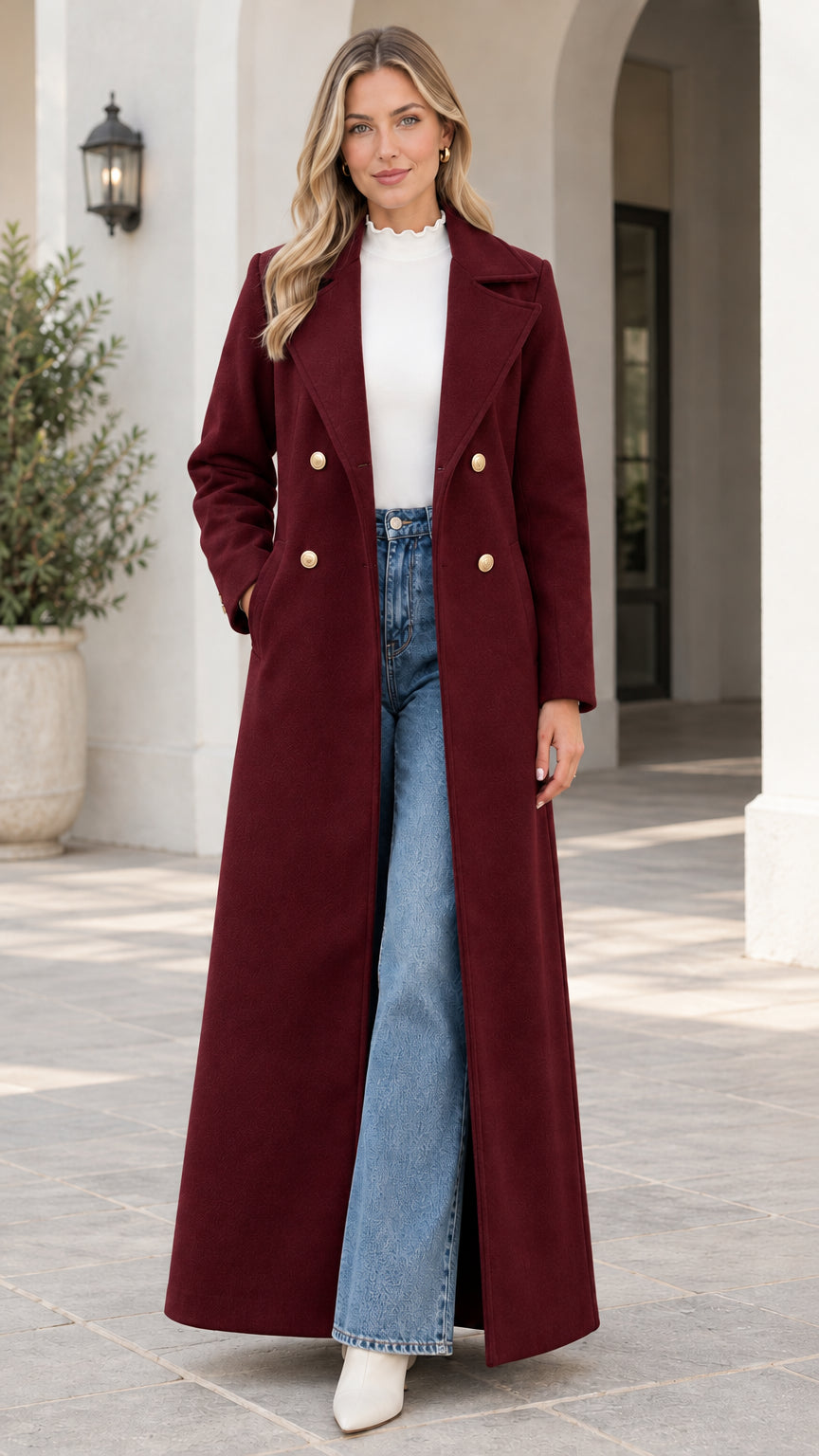 Front view of model wearing the double-breasted floor-length maxi coat in burgundy wine