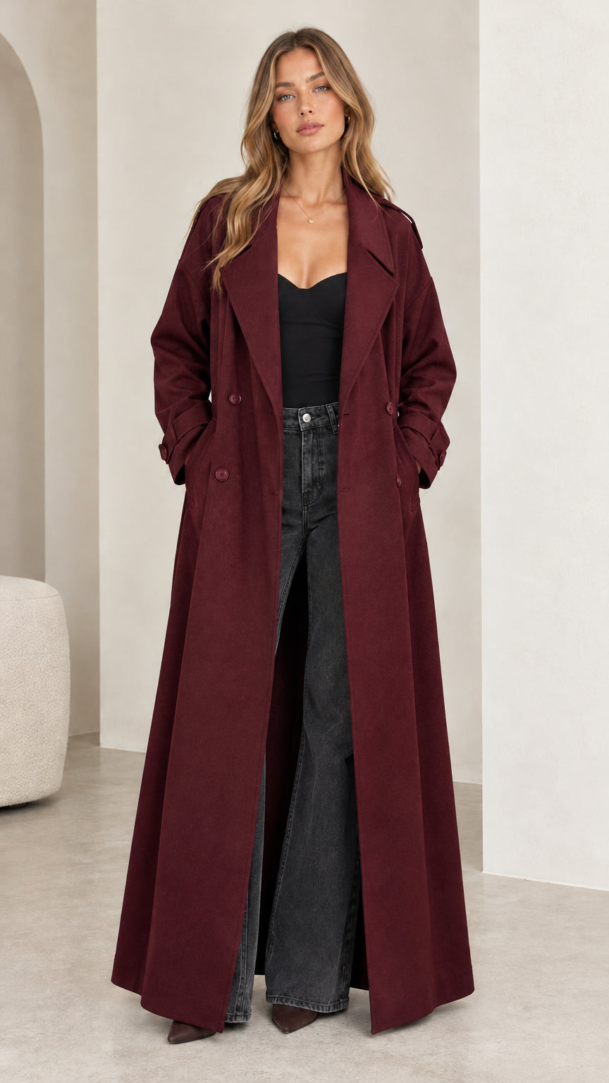 Full front view of model wearing the floor-length burgundy double-breasted trench coat