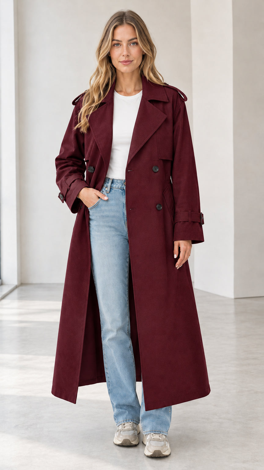 Full-length view of woman modeling the long burgundy double-breasted trench coat