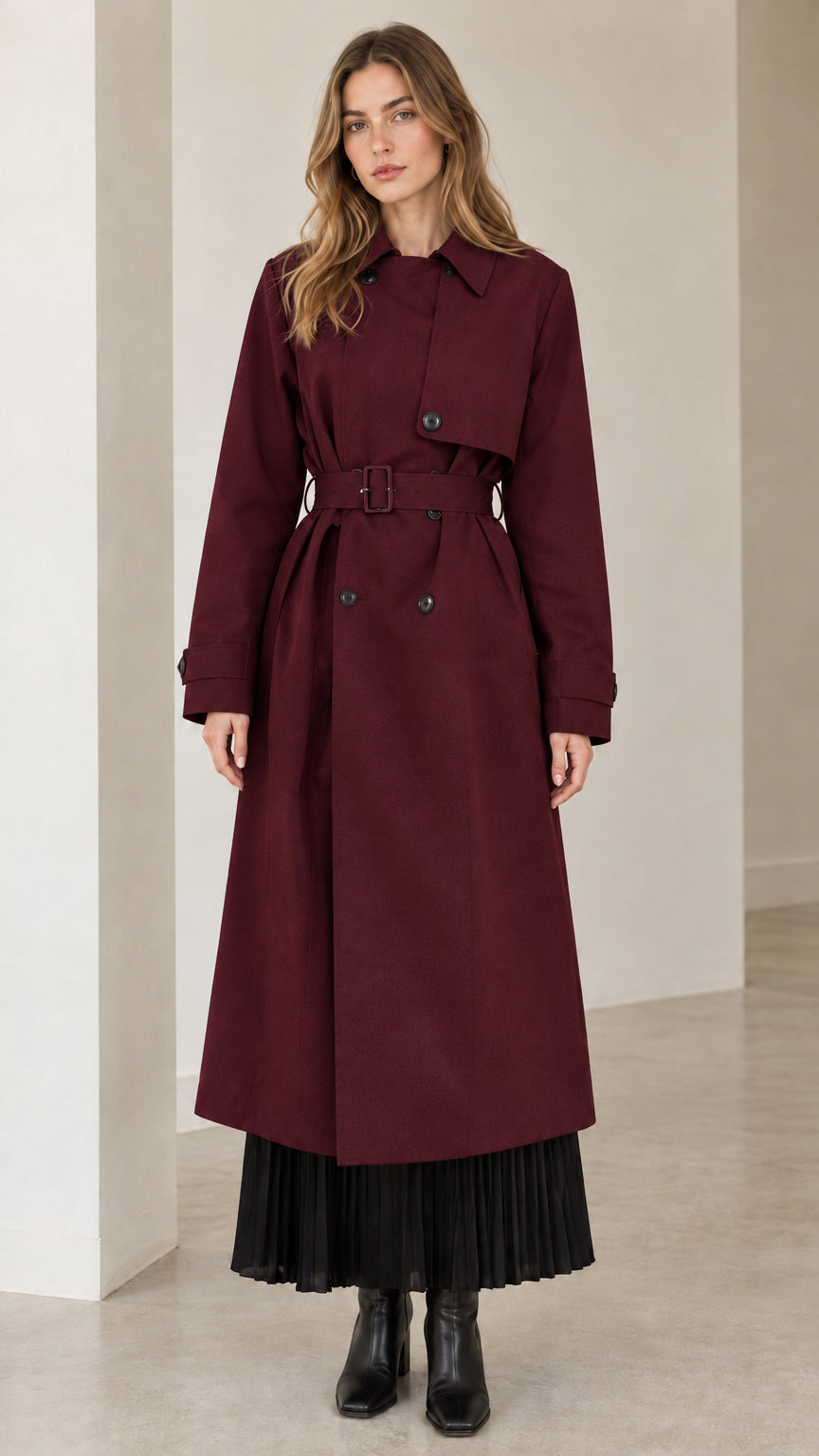 Front view of model wearing deep burgundy red maxi belted trench coat