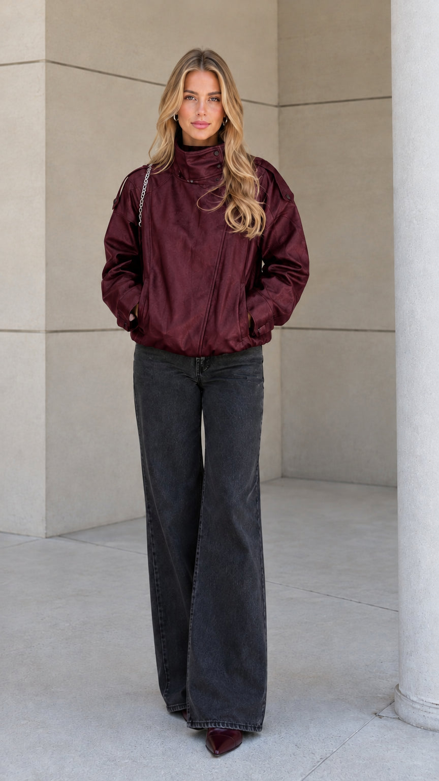 Front view of model wearing the burgundy high-neck zip-up bomber jacket