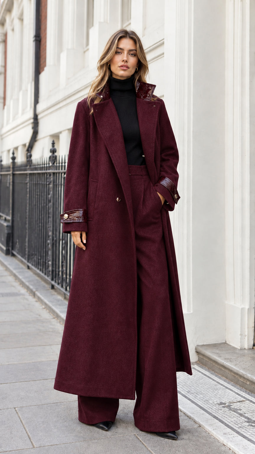 Full-length front view of woman wearing deep burgundy wine maxi tailored overcoat and matching trousers