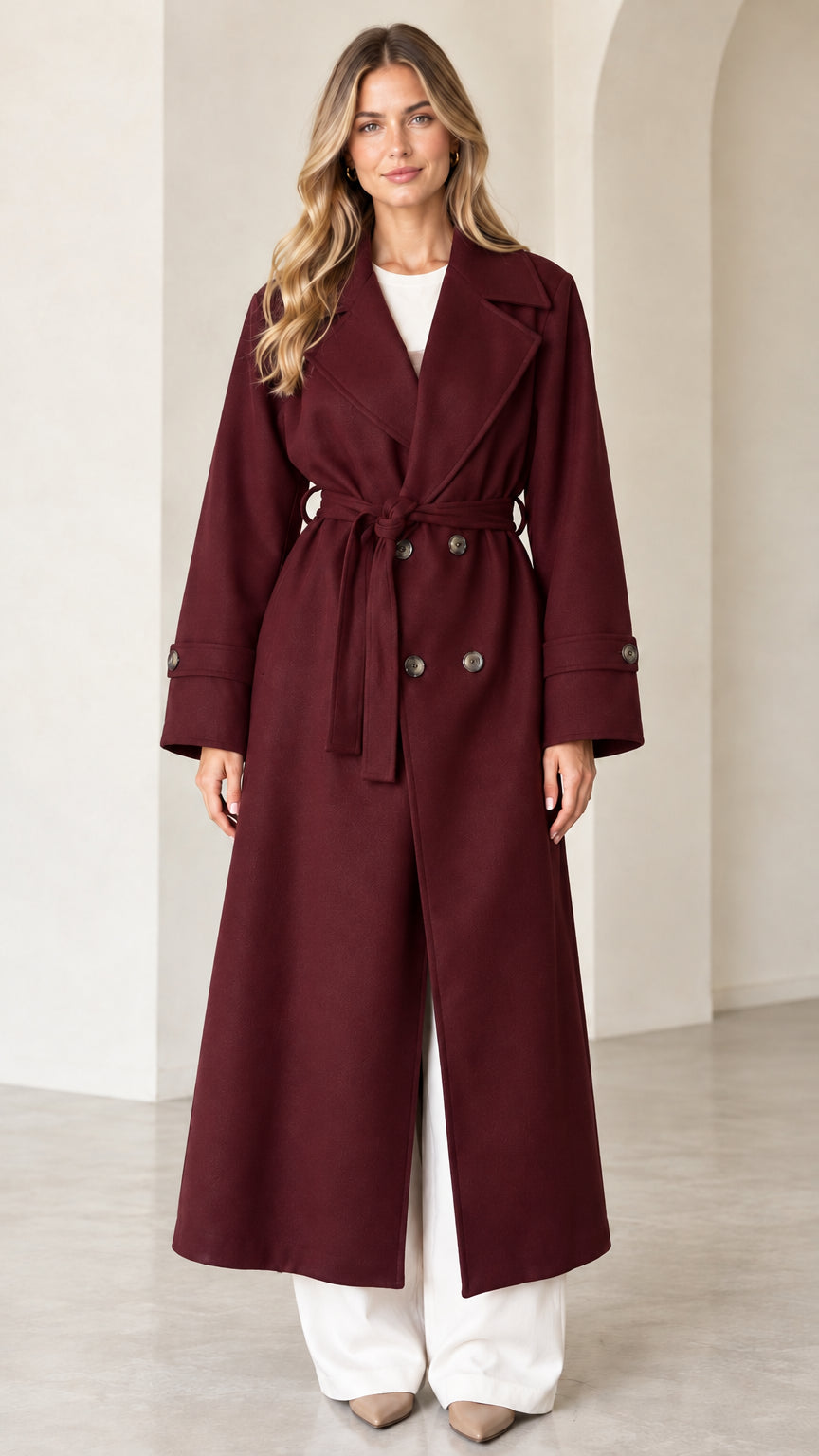Front view of model wearing burgundy wine double-breasted maxi coat