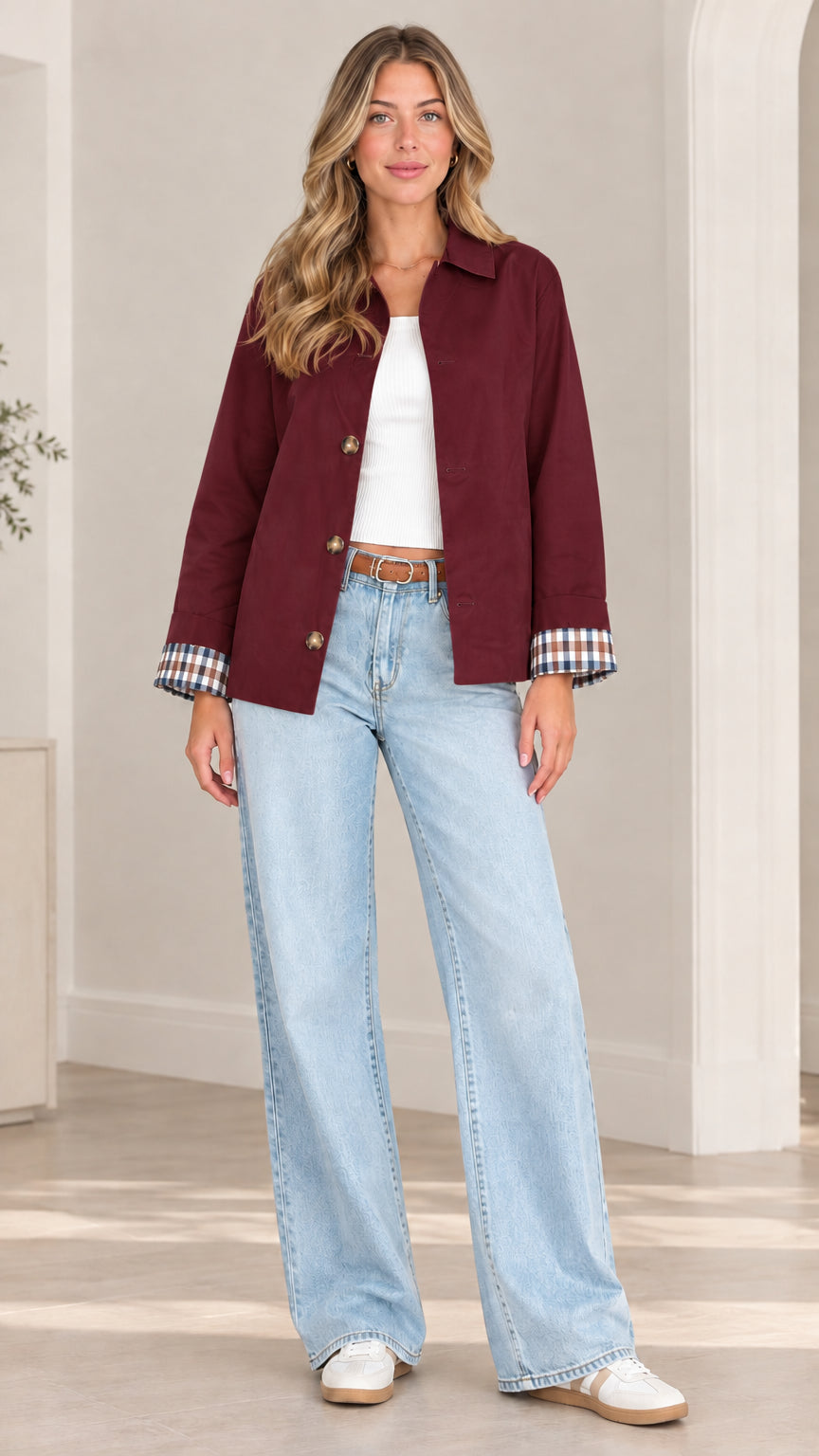Front view of model wearing burgundy wine-red button-front shirt jacket with plaid cuff details