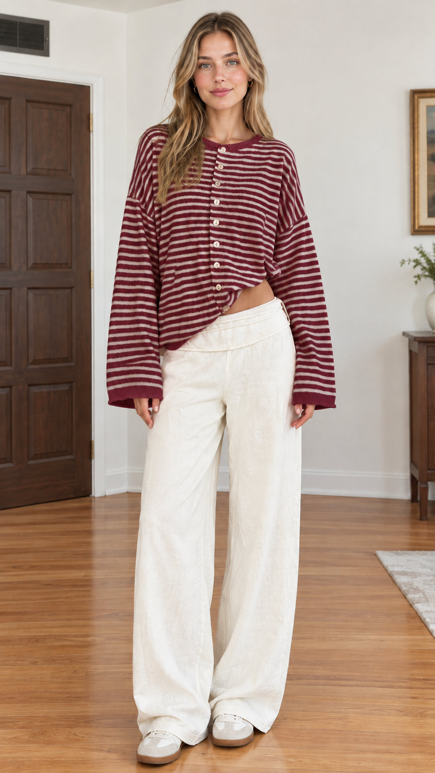 Full-length studio shot of burgundy and white striped button-front cardigan on model