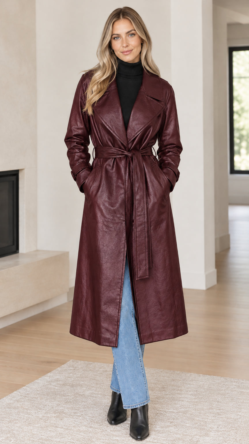 Front full view of woman wearing burgundy wine faux leather belted trench coat