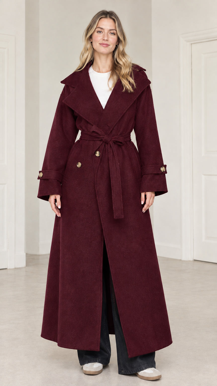 Front full-length view of woman wearing burgundy wine red maxi belted trench coat