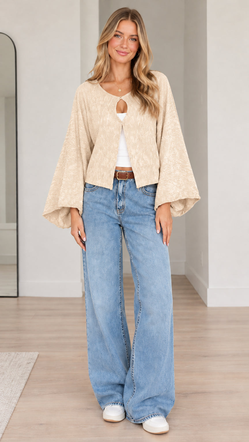 Model wearing beige cream textured bell sleeve cardigan