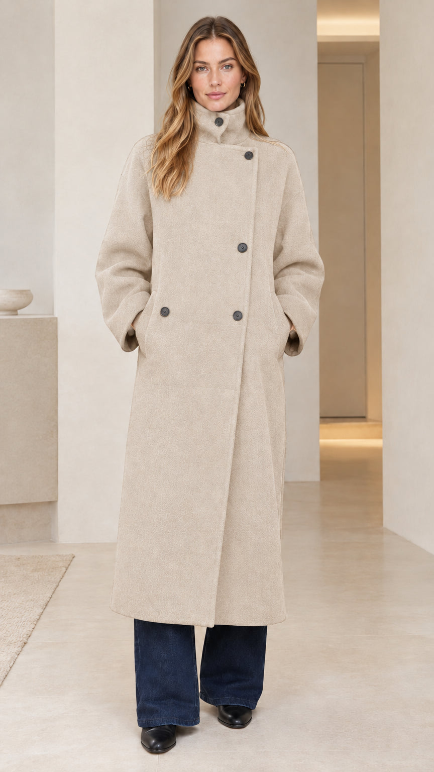 Front view of model wearing oatmeal cream full length stand collar overcoat
