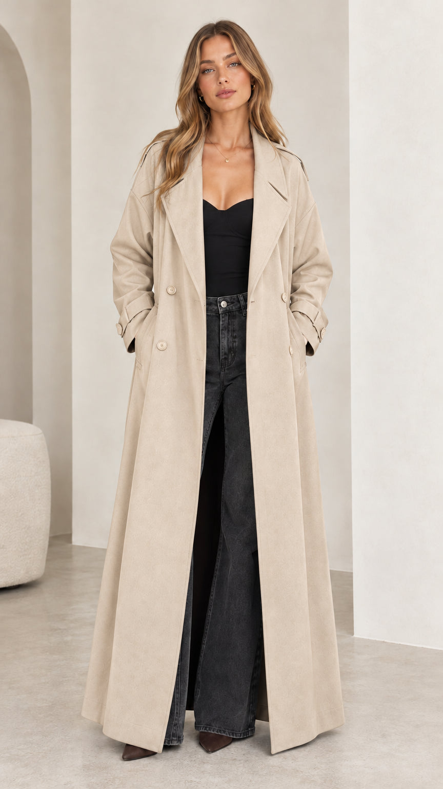 Full front view of model wearing the floor-length beige double-breasted trench coat
