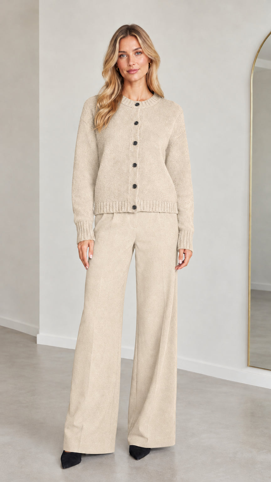 Front view of model wearing Cream knit button-down cardigan and wide-leg trousers