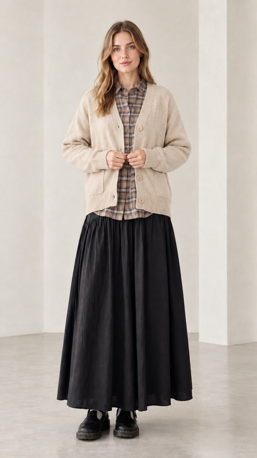 Front view of woman wearing beige oatmeal V-neck button-front knit cardigan sweater