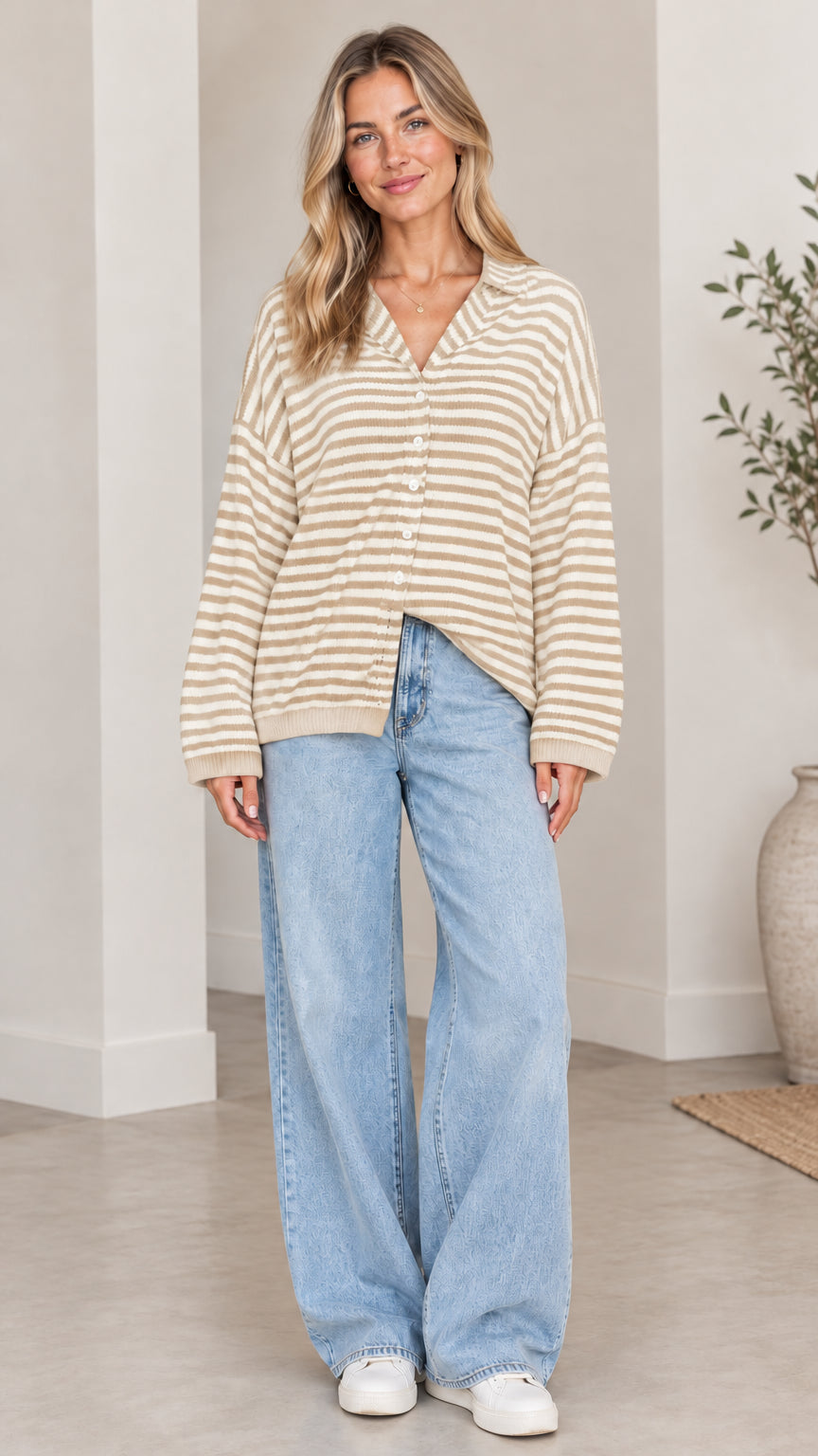 Front full-length view of woman wearing beige and white striped collared cardigan sweater