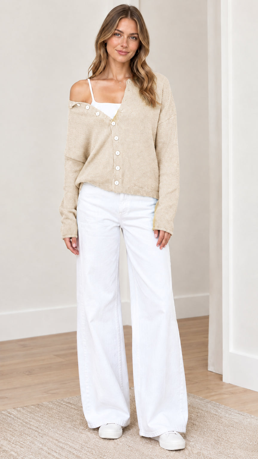 Front view of woman wearing beige oatmeal asymmetrical button-down knit cardigan sweater
