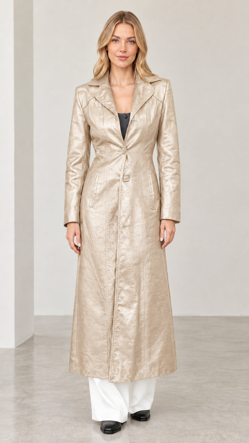 Full-length front view of woman wearing champagne gold metallic textured faux leather maxi coat