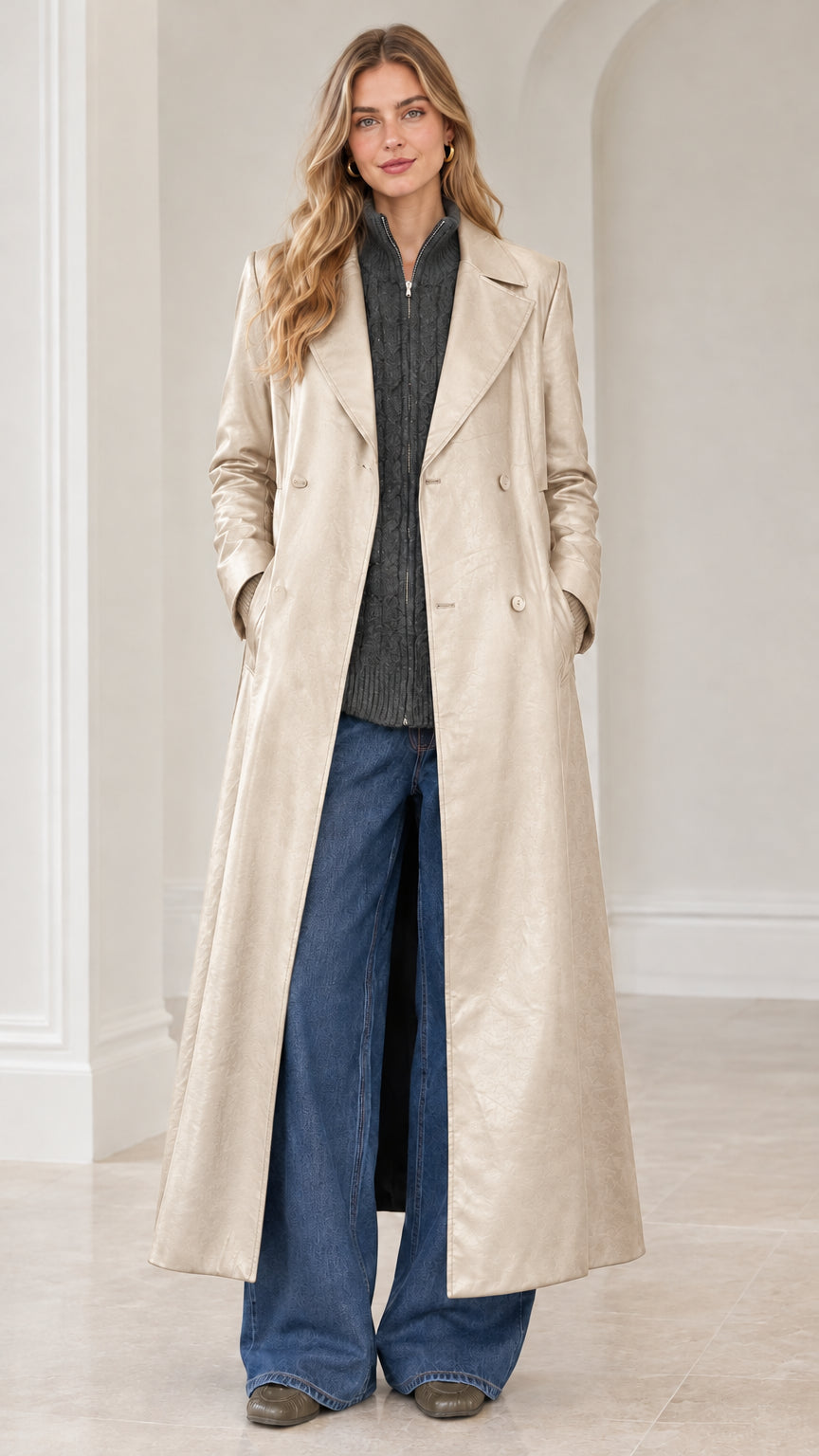 Full-length front view of model wearing cream off-white faux leather maxi trench coat