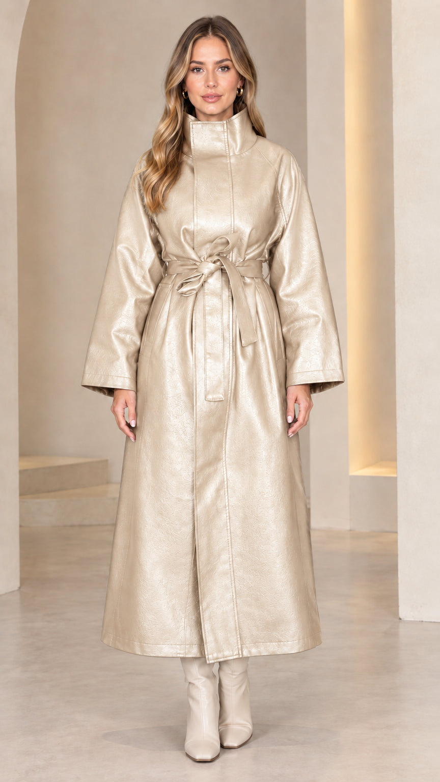 Front view of model wearing champagne beige metallic faux leather maxi coat