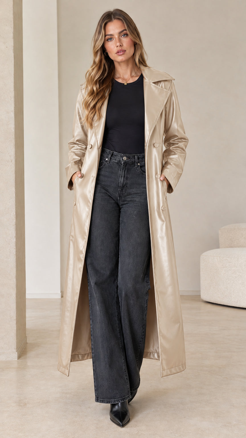 Front view of model wearing a champagne metallic beige faux leather maxi trench coat with relaxed drape