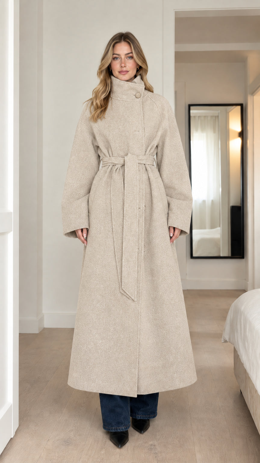 Front full-length view of model wearing oatmeal cream high-neck belted maxi coat