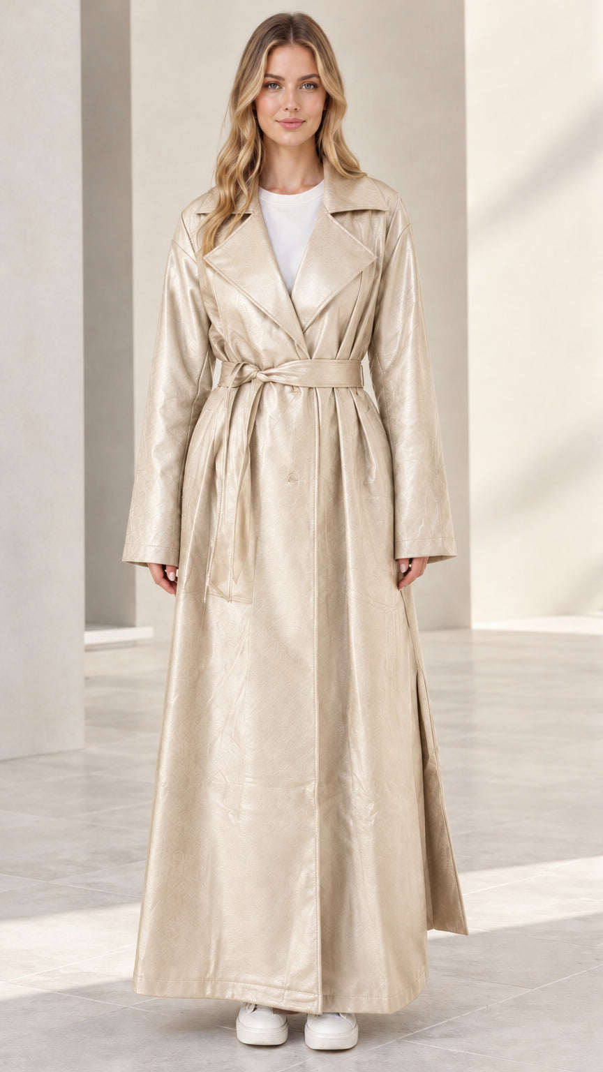 Front view of woman wearing champagne beige maxi faux leather trench coat
